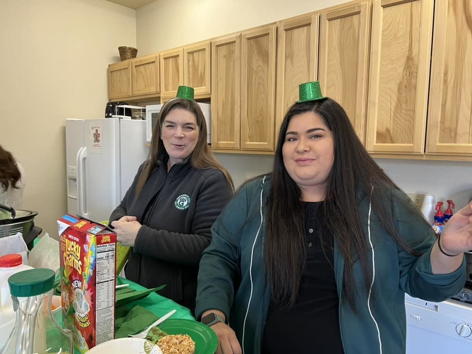 Two people with green St. Patrick's Day Hats on
